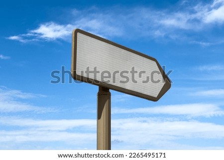 Blank right directional signpost with blue sky in the background