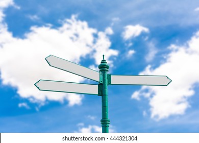 Blank Road Sign On Blurry Blue Sky And White Clouds Background With Clipping Path