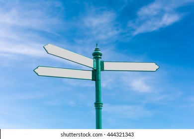 Blank Road Sign On Blurry Blue Sky And White Clouds Background With Clipping Path