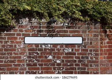 Blank Road Sign On A Brick Wall