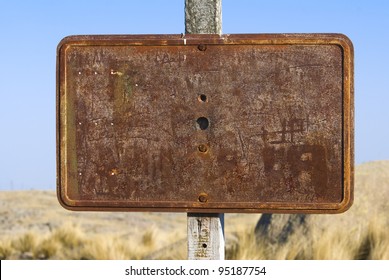 A Blank Rusty Sign In A Arid Region