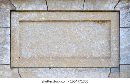 Blank Sandstone Panel With Copyspace. Ancient Light Brown Stone Slab With Carved Frame. Stone Frame On Old Wall.