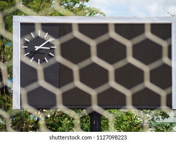 Blank Score Board And Clock With Blurry Goal Net At Football Stadium.Outdoor Sport.