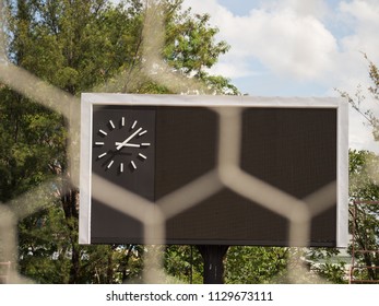 Blank Score Board And Clock With Blurry Goal Net At Football Stadium. Outdoor Sport.