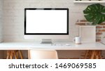 Blank screen desktop computer in minimal office room with decorations and copy space 