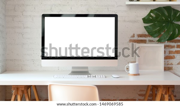 Blank screen desktop computer in minimal\
office room with decorations and copy space\
