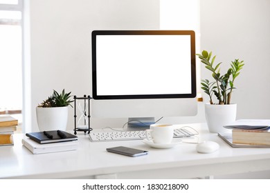 Blank screen desktop computer in minimalist decorated workspace - Shutterstock ID 1830218090