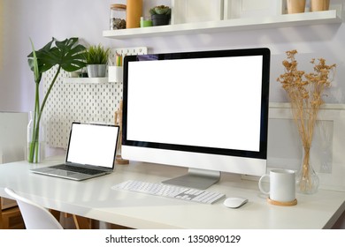 Blank screen desktop computer on loft workspace - Shutterstock ID 1350890129