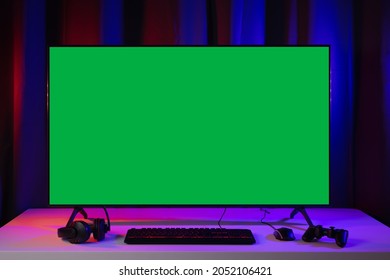 Blank screen display computer pc with gaming gear joystick mouse keyboard mouse. Gamer gadget background in game station.