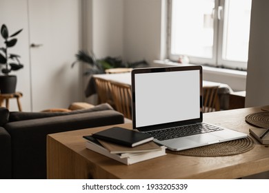 Blank screen laptop computer. Home office desk table workspace. Modern nordic interior design. Copy space mockup template. Front view work at home, pandemic quarantine self-isolation business concept.