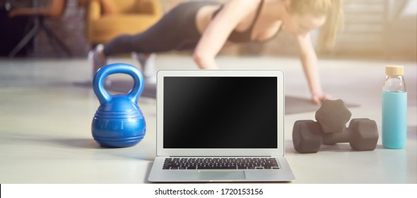 Blank Screen Laptop And Fitness Equipments At Home. Concepts About Online Workout Program, Fitness Video, Home Workout.