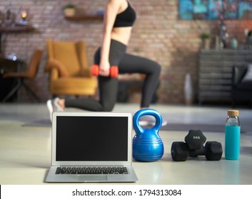 Blank Screen Laptop And Fitness Equipments At Home. Concepts About Online Workout Program, Fitness Video, Home Workout.