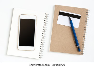 Blank Screen Of Mobile On Notebook Paper With Pvc Card And Pen On Office Desk