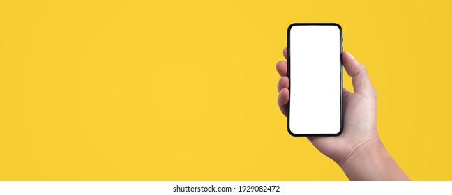 Blank screen of Mobile phone with Hand holding on solid color background. of free space for your copy, view from top. Creativity ideas concept. - Shutterstock ID 1929082472