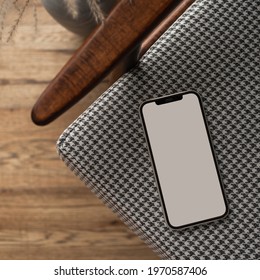 Blank Screen Mobile Phone On Vintage Chair. Flat Lay, Top View Minimalist Blog, Website, App Template. Copy Space Smartphone Mockup.