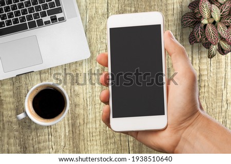 Blank screen view on the smartphone in human hands