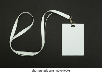 Blank Security Tag with White Neck Band Isolated on Black Background. - Shutterstock ID 629999096
