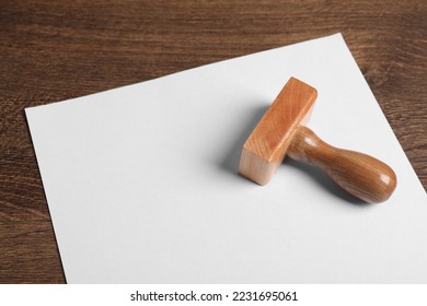 Blank sheet of paper and visa stamp on wooden table - Shutterstock ID 2231695061