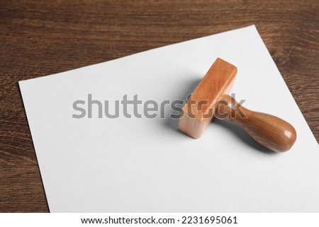 Blank sheet of paper and visa stamp on wooden table