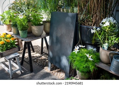 Blank Shop Sign Or Menu Board Near The Entrance To Flower Shop Or Cafe. Blackboard Sign Mockup In Front Of A Restaurant. Signboard, Freestanding A-frame Blackboard.