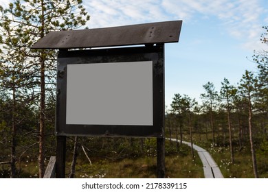 Blank Sign Along Wooden Duckboard Trail On A Swamp In Finland