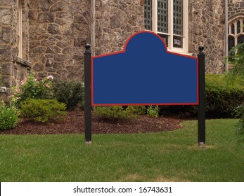 Blank Sign By A Stone Church And Grass Lawn