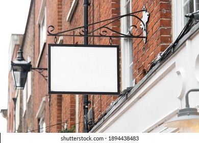 Blank Sign Mockup In The Urban Environment, On The Facade, Empty Space To Display Your Store Sign Or Logo