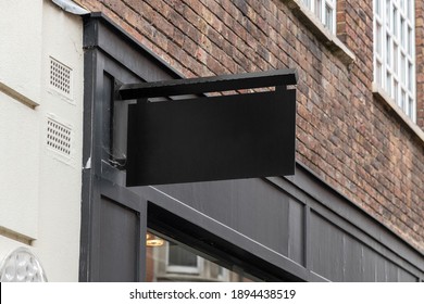 Blank Sign Mockup In The Urban Environment, On The Facade, Empty Space To Display Your Store Sign Or Logo