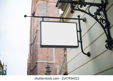 Blank Sign Mockup In The Urban Environment, On The Facade, Empty Space To Display Your Store Sign Or Logo