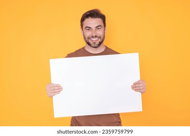 Blank signboard, billboard or banner with copy space. Happy attractive handsome smiling middle aged man showing promo blank board on studio background. Advertisement concept. Blank mockup. - Powered by Shutterstock