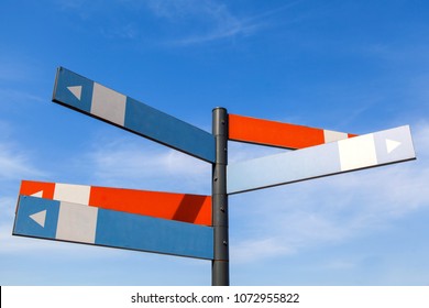 Blank signpost with many directions against blue sky in sunny day. Mockup.