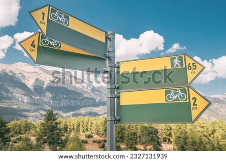 blank signpost on a hiking and cycling tourist route in Alps