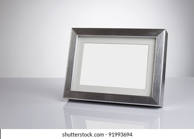 Blank Silver Picture Frame At The Desk With Clipping Path