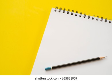 Blank Sketch Book With Pencil On Yellow Background