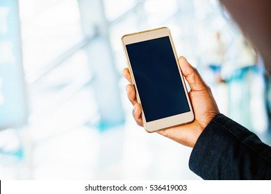 Blank Smartphone Screen. Dark Skin Hand Holding A Phone