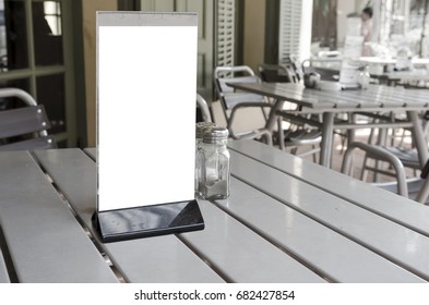 Blank space of information label stand on the table cafe, restaurant background
