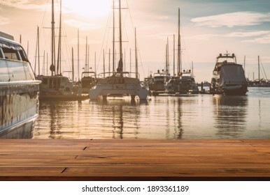 Blank space of wooden plank floor at marina, blurred background of sea, yachts and sunset sky. Warming looks view of yacht dock. - Powered by Shutterstock