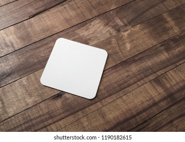 Blank Square Beer Coaster On Wooden Background.