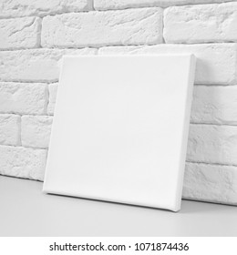 Blank Square Canvas Against The Wall. Mockup Poster.