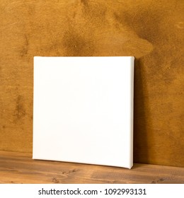 Blank Square Canvas On Wooden Background. Side View. Mock Up Poster For Design.