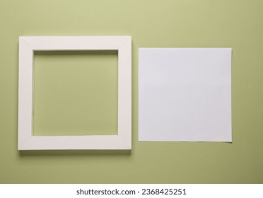Blank square frame with white sheet of paper on green background