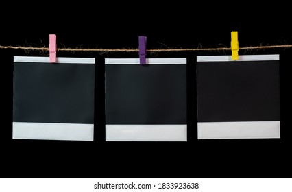 Blank square photo frames hanging on a clothesline. - Shutterstock ID 1833923638