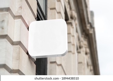 Blank Square Sign Mockup In The Urban Environment, On The Facade, Empty Space To Display Your Store Sign Or Logo