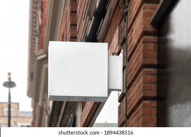 Blank Square Sign Mockup In The Urban Environment, On The Facade, Empty Space To Display Your Store Sign Or Logo