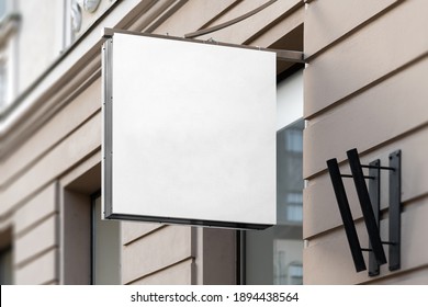 Blank Square Sign Mockup In The Urban Environment, On The Facade, Empty Space To Display Your Store Sign Or Logo