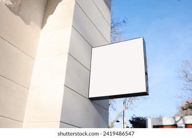 Blank square store signage for mockup. Square signboard hanging on the wall. Signboard for logo presentation.