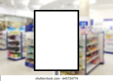 Blank Standing Sign With Copy Space For Text Message Or Mock Up Content In Abstract Blur Background Inside Pharmacy Store With Shelves Of Pharmaceutical And Drug.