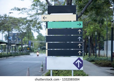 Blank steel signpost or guide post with direction arrows.