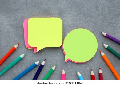 Blank Stickers For Notes On A Gray Background With Multicolored Pencils. Sticky Note Paper Mockup. Ideas For A Note. Business Discussion, Teamwork, Brainstorming Concept