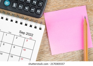 The Blank sticky note on September 2022 desk calendar on wooden background for your text. - Shutterstock ID 2170305557